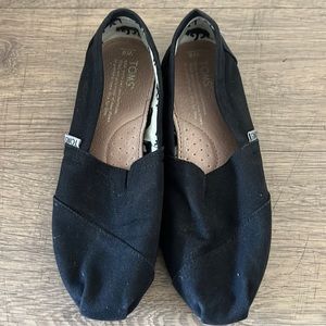 Toms black slip ons